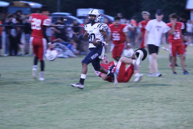Shawnee senior Deetrick Beavers carries the ball during the scrimmage at McLoud on Aug. 29. They played half a game, and the Redskins beat the Wolves, 19-14. Countywide &amp; Sun/Natasha Dunagan