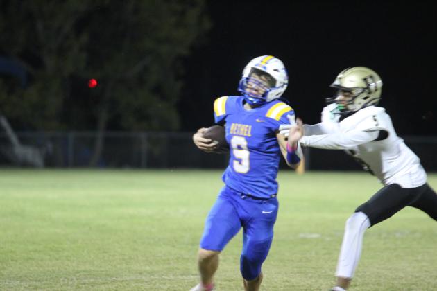 Bethel sophomore Maddox Davis tries to dodge being tackled while carrying the ball at the Oct. 4 home game with Hugo. The Wildcats lost, 24-38. Countywide &amp; Sun/Natasha Dunagan