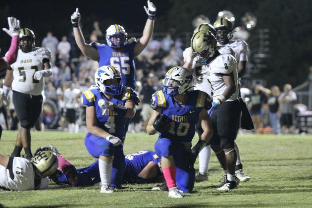 The teammates of Bethel junior Luke Quinter (#10) congratulate him after making a touchdown during the third quarter of the Oct. 4 "Pink Out" home game with Hugo. The Wildcats lost, 24-38. Countywide &amp; Sun/Natasha Dunagan