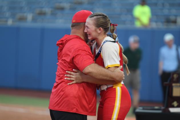 Dale's Teague Muncy hugs her father, Principal and Assistant Coach Erick Muncy, and sheds some happy tears after being presented her medal. Her single at bat brought in the winning run in the seventh inning of the OSSAA Class 2A Fast-Pitch Softball State Championship on Oct. 12. Countywide &amp; Sun/Natasha Dunagan
