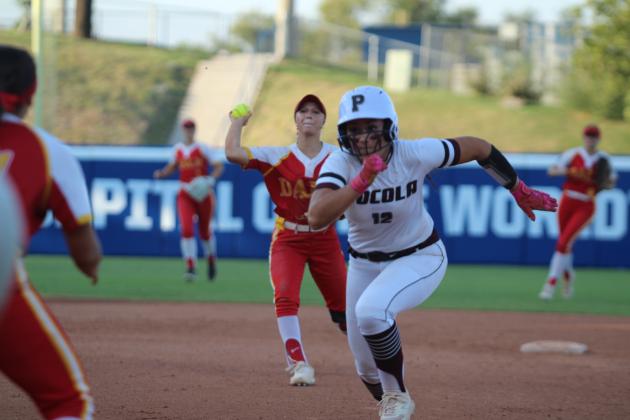 Dale's Reese Herring throws from second to Kaylyn Solis for an out as the Pocola runner returns to first during the OSSAA Class 2A Fast-Pitch Softball State Championship against Pocola, held at Devon Park (formerly USA Softball Hall of Fame Stadium) on Oct. 12. The Lady Pirates topped Howe, 10-0, on Oct. 10, and beat Oktaha, 2-0, on Oct. 11, before narrowly claiming victory with Pocola, 1-0. The score was 0-0 until the bottom of the seventh inning when Dale finally got one across home plate.