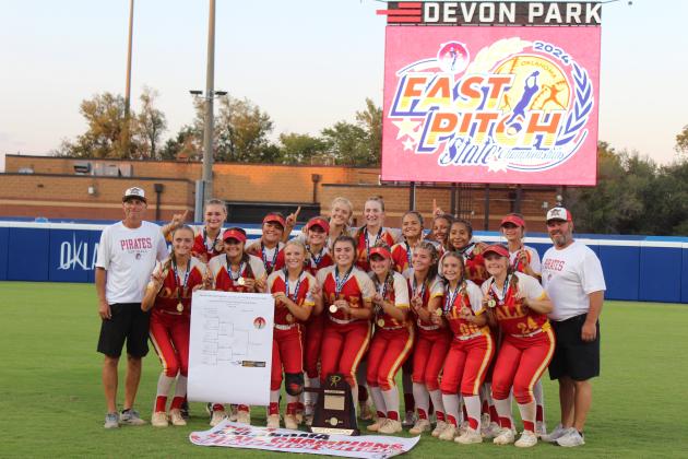 The Dale Lady Pirates Fast-Pitch Softball Team poses with their medals, tournament bracket and banner after winning the OSSAA Class 2A Fast-Pitch Softball State Championship against Pocola, held at Devon Park (formerly USA Softball Hall of Fame Stadium) on Oct. 12. The Lady Pirates topped Howe, 10-0, on Oct. 10, and beat Oktaha, 2-0, on Oct. 11, before narrowly claiming victory with Pocola, 1-0. The score was 0-0 until the bottom of the seventh inning when Dale finally got one across home plate.