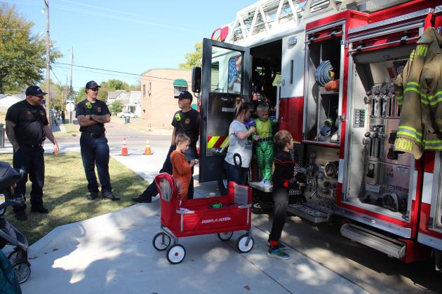 Shawnee Firefighters Travis Cooley, Braylee Dickerson and Brandon Don handed out treats and offered  tours of their ladder truck during the Enchanted Woodland event at Woodland Veterans Park on Oct. 26. The Shawnee Police Department also brought treats, and Officers Cotton, Cameron and Tucker, as well as Corporal Lozano, Sergeant Keehn and Captain Stafford handed them out. Several organizations and businesses participated, and at least 500 children, plus their parents, attended.