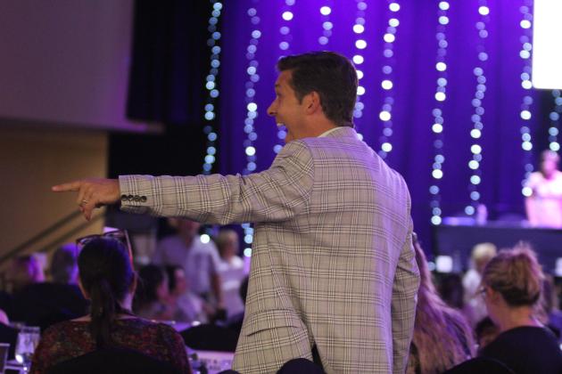 State Senator Shane Jett serves as a barker at the Honey Do Auction.
