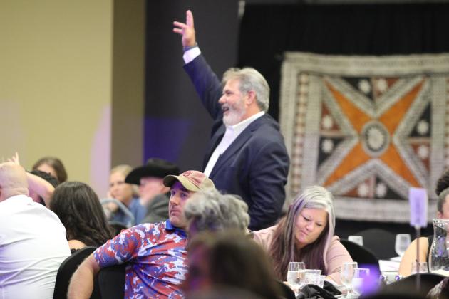 Shawnee Mayor Eric Stephens calls attention to a bidder.