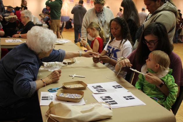Mabee-Gerrer Museum of Art volunteer Gerry Pfeil explains how to make mummies from popsicle sticks and yarn during Mummy Day at the museum on Oct. 26. Countywide &amp; Sun/Natasha Dunagan
