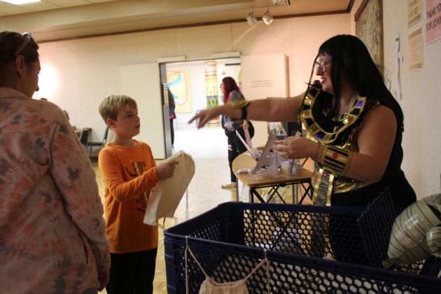 Dressed as Cleopatra, Mabee-Gerrer Museum of Art Director of Development Sylwia Partyka hands out string backpacks during Mummy Day at the museum on Oct. 26. Countywide &amp; Sun/Natasha Dunagan
