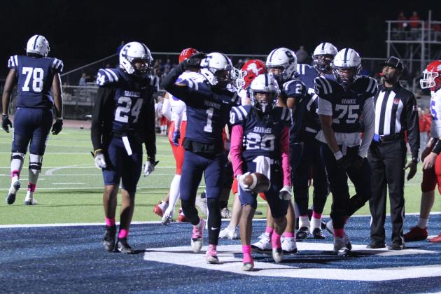 Shawnee senior Deetrick Beavers (#20) celebrates with his teammates after breaking away from the Durant defense and making a touchdown at the end of the first quarter in the Oct. 18 homecoming game. The Wolves won, 28-7. Countywide &amp; Sun/Natasha Dunagan