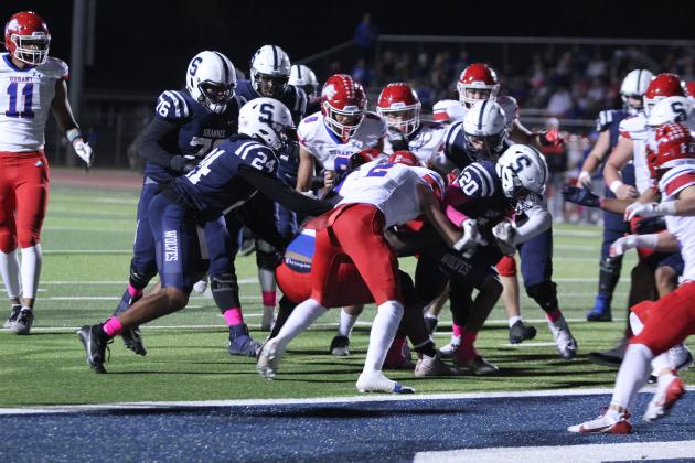 Shawnee senior Deetrick Beavers (#20) tries to break away from Durant's defense and cross into the endzone for a touchdown at the end of the first quarter in the homecoming game with Durant on Oct. 18. Beavers did succeed. The Wolves won, 28-7. Countywide &amp; Sun/Natasha Dunagan