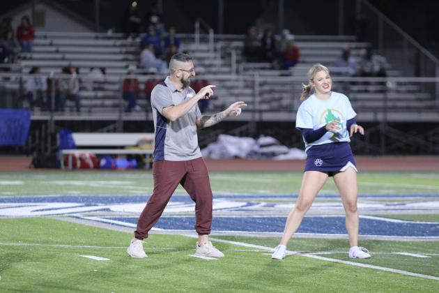 Shawnee Head Wrestling Coach Andrew McCune and cheerleader Brooke Moody dance to "Thriller" by Michael Jackson at halftime of the homecoming game, Oct. 18. Sixteen teachers, coaches and one school board member paired with cheerleaders and took turn dancing for the event. Countywide &amp; Sun/Natasha Dunagan