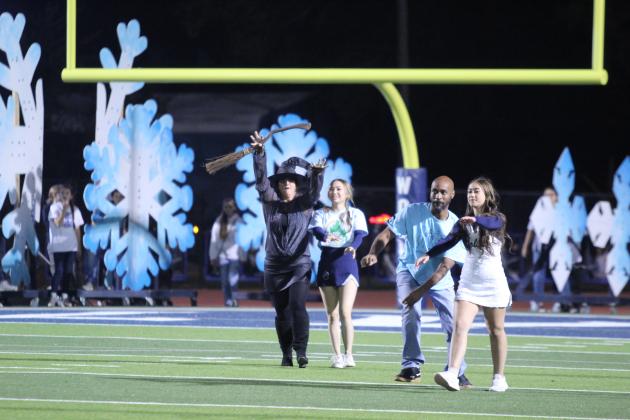 With the Shawnee Fall Homecoming theme, "There's No Place Like Homecoming," the "Wicked Witch of the West" - aka SHS Spanish teacher Claudia Hale - accompanies cheerleaders LaNayah Shawnee and Alivia Snow, along with SHS Geometry teacher Dion Cooley, after their Michael Jackson "Thriller" dance during halftime on Oct. 18. Sixteen dancing duos of cheerleaders with teachers, coaches and one school board member entertained the crowd. Countywide &amp; Sun/Natasha Dunagan