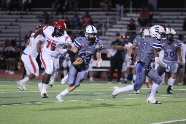 Shawnee senior Lance Williams carries the ball after intercepting a pass made by East Central during Jim Thorpe Night on Sept. 27. The Wolves won, 28-7. Countywide &amp; Sun/Natasha Dunagan