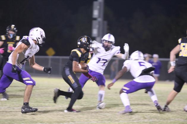 Tecumseh junior Jekhi Owens makes his way around a few Chickasha defenders during the district home game on Oct. 25. The Savages lost in overtime, 41-47. Countywide &amp; Sun/Natasha Dunagan