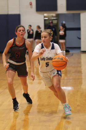 Asher’s Delanie Templeton takes it up the court.