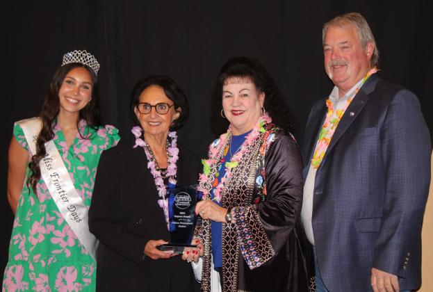 Last year's award recipients Suzanne and Randy Gilbert, third and fourth from left, present the Impact Award to Linda Capps, Vice Chair of the Citizen Potawatomi Nation, during the Tecumseh Chamber of Commerce Annual Meeting &amp; Awards Banquet, held at the Grand Casino Hotel and Resort on Nov. 21. Capps is accepting the award for CPN. Also shown is Miss Frontier Days Jalee Meyers. Countywide &amp; Sun/Natasha Dunagan