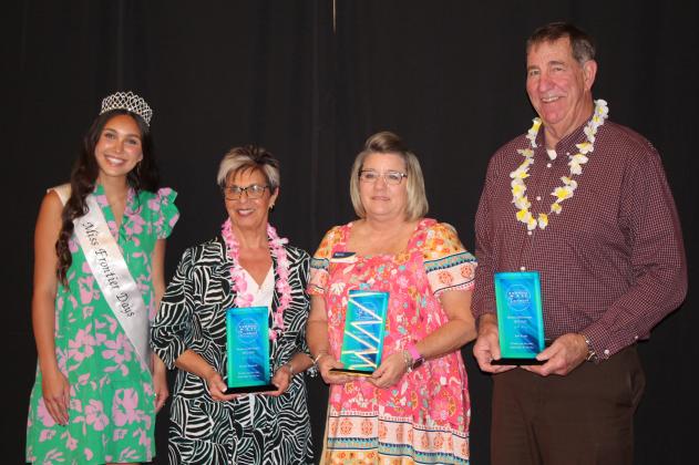 Accompanied by Miss Frontier Days Jalee Meyers, far left, Brenda Kennedy, Kellie Clay and Bob Evans received trophies for their service to the Tecumseh Chamber of Commerce Board of Directors. Their retirement was announced during the Annual Meeting &amp; Awards Banquet, held at the Grand Casino Hotel and Resort on Nov. 21. Countywide &amp; Sun/Natasha Dunagan