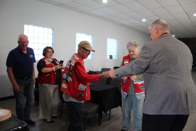Rev. Jonker hands out patches to the Church Mobilization RV Volunteer group.