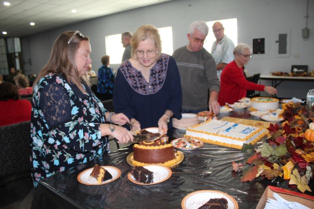 Alana Buchanan serves cake.