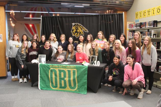 Tecumseh senior Jessi Hull poses with the fast-pitch softball team after signing with OBU on Nov. 19.