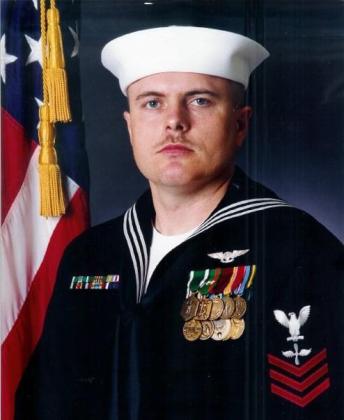 Tecumseh Assistant Police Chief Mike Mallinson is shown in his U.S. Navy dress uniform in 1995, after being awarded “Sailor of the Year” while attached to VQ-5 in San Diego. Mallinson retired from the Navy after 20 years, having served on four aircraft carriers as a jet engine mechanic and In-Flight Technician. He also had shore duty in Puerto Rico and San Diego, had a seven-month deployment in Iraq during the Gulf War, and served as a recruiter in Shawnee and a classifier at the MEPS. See full cutline.