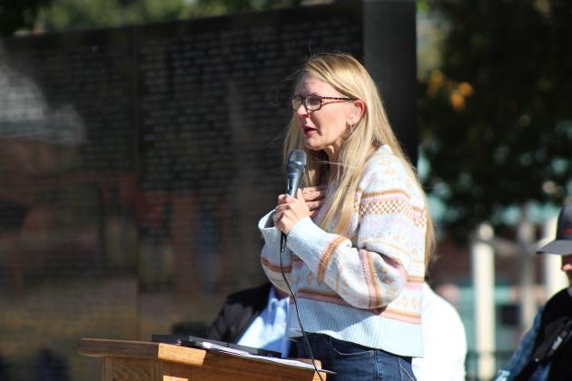Pottawatomie County Commissioner Melissa Dennis speaks during the Pottawatomie County Veterans Memorial and Museum Veterans Day Program, held at the Woodland Veterans Park in Shawnee on Nov. 11. Dennis planned to donate a couple of photos of her grandfather to the new museum, which is in the former District Attorney and Carnegie Library building. Countywide &amp; Sun/Natasha Dunagan