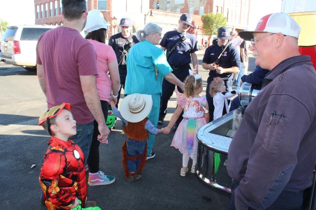 Grayson Springer, 5, of Tecumseh, talks with Tecumseh Fire Chief Rhett Banks during the Tecumseh Business Trick or Treating on Oct. 31. Countywide &amp; Sun/Natasha Dunagan