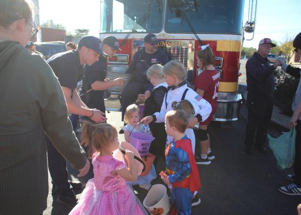 Tecumseh Firefighters give away candy during the Tecumseh Business Trick or Treating on Oct. 31. Countywide &amp; Sun/Natasha Dunagan