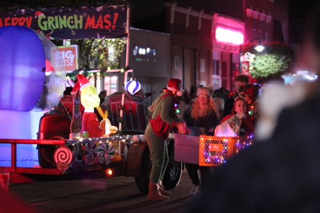 People walk and ride alongside the Big Lots! float in the Grinchmas Parade in Tecumseh on Dec. 5. Countywide &amp; Sun/Natasha Dunagan