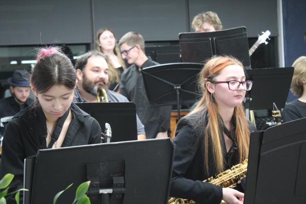 SHS Band Director Christopher Hall, second row, listens to the Jazz Choir sing him "Happy Birthday."