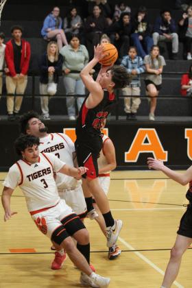 Macomb freshman Aiden Tittle aims at the basket but gets fouled by Maud's defense during the Dec. 9 game at Maud.. The Tigers won, 72-64. Countywide &amp; Sun/Natasha Dunagan