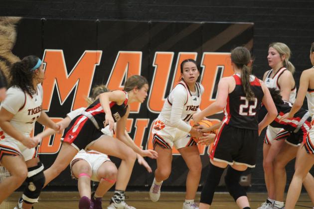 After grabbing the rebound, Maud's Abi Horton tries to guard the ball from several Macomb defenders during the Dec. 9 home game. The Lady Tigers won, 49-41. Countywide &amp; Sun/Natasha Dunagan
