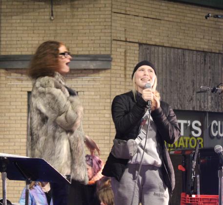 Fhionna Schaughnessy reacts as 2023 Miss Frontier Days Aleigha McCullough sings a Mariah Carey song during the Shawnee Parade of Lights fireworks on Dec. 13. Countywide &amp; Sun/Natasha Dunagan