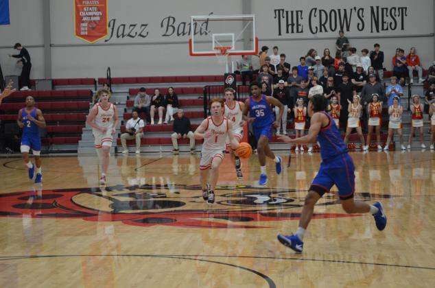 Dale's Easton Edmonson takes the ball up the court during the Jan. 17 homecoming game against Millwood. The Pirates won, 64-57. Countywide &amp; Sun/Jessica Jones