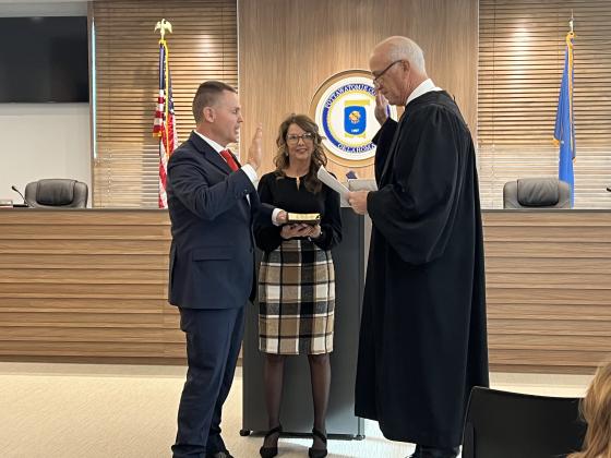 Oklahoma Supreme Court Justice Douglas L. Combs (right) swears in newly-elected Sheriff Freeland Wood (left). Holding the bible is Wood’s wife, Shirley. This is the first time in 16 years that Pottawatomie County has sworn in a new Sheriff. Photo provided.