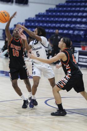Shawnee senior Deetrick Beavers passes in the Jan. 7 home game with Booker T. Washington. The Wolves lost, 48-66, and the Lady Wolves also fell, 40-43. Countywide &amp; Sun/Natasha Dunagan