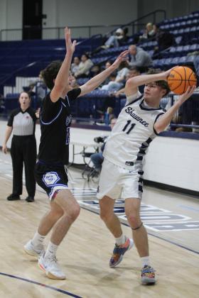 Shawnee senior Carter Whipkey looks to pass during the Shawnee Invitational game with Choctaw on Jan. 25. Countywide &amp; Sun/Natasha Dunagan
