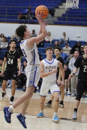 After an assist from Zack Jennings, Bethel junior Darius Cheatham adds two points to the board in the Class 3A District game with Marietta on Feb. 22. The Wildcats won, 67-41, and will play in regionals today at 7:30 pm at home. Countywide &amp; Sun/Natasha Dunagan