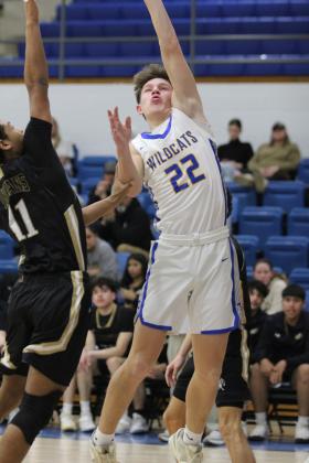 Bethel sophomore Maddox Davis takes an assist from Darius Cheatham and sinks the shot in the Class 3A District game with Marietta on Feb. 22. The Wildcats won, 67-41, and will play in regionals today at 7:30 pm at home. Countywide &amp; Sun/Natasha Dunagan