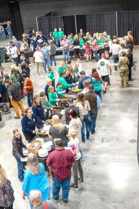 Attendees line up for the traditional PCJLS Trophy Auction dinner, served by 4-H and FFA members. Approximately 575 meals were served before the record-breaking auction began. Photo provided