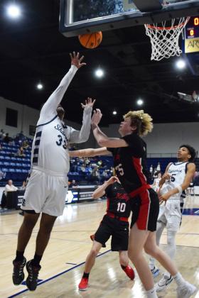 Aidon Siqueiros puts the first two points on the board in the homecoming game against Bishop Kelley. The Wolves lost 46-52. Countywide &amp; Sun/Julie Talton