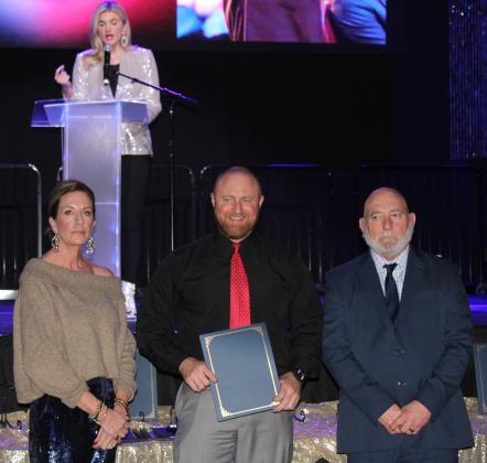 Corporal Brad Sherrill accepts a Life-Saving Award during the 20th Annual "Celebration of Heroes" Shawnee Police Foundation Awards Banquet, held at the Grand Casino Hotel and Resort on Jan. 31. Sherrill responded to an emergency at North Rock Creek Elementary where a child had severely cut their arm. He applied a tourniquet until the child was transported to OU Medical Children's Hospital for surgery. Also shown are SPF Chair Melissa Stuteville, left, and Deputy Chief John Goss.