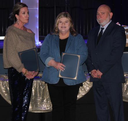 BancFirst Employee Paula Smith, center, receives a Civilian Service Award for reporting a revenge shooting being planned last year, during the 20th Annual "Celebration of Heroes" Shawnee Police Foundation Awards Banquet on Jan. 31. Also shown are SPF Chair Melissa Stuteville, left and Deputy Chief John Goss. Countywide &amp; Sun/Natasha Dunagan