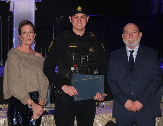 Officer Jared Thorpe accepts a Life-Saving Award at the 20th Annual "Celebration of Heroes" Shawnee Police Foundation Awards Banquet, held at the Grand Casino Hotel and Resort on Jan. 31. Thorpe performed CPR on someone in cardiac arrest until firefighters arrived with an defibrillator, and then continued CPR until emergency medical personnel got there. Also shown are SPF Chair Melissa Stuteville, left, and Deputy Chief John Goss. Countywide &amp; Sun/Natasha Dunagan