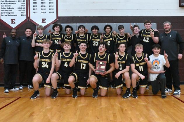 The Tecumseh High School Savages pose with their coaches after winning the Class 4A District Tournament at Eufaula on Feb. 21. Photo courtesy of Kenetta Lisenbee.