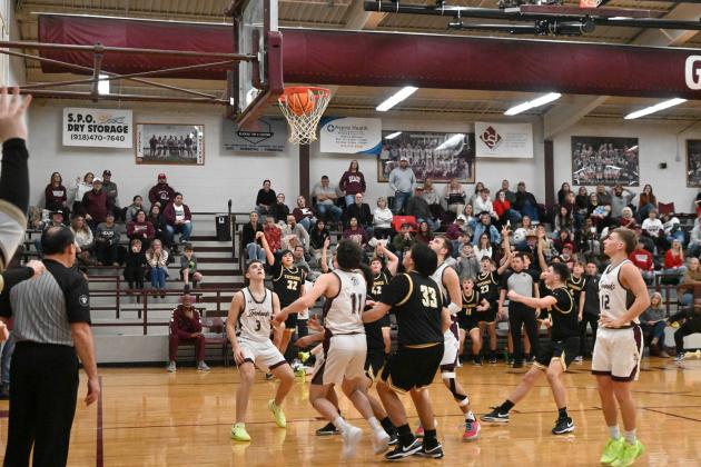 Tecumseh junior Sampson Martin sinks a three-point shot in the last two seconds of play at the Class 4A District Tournament in Eufaula on Feb. 21. This was the winning shot with a final score of 69-67. Photo courtesy of Kenetta Lisenbee.