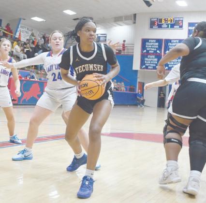 Tecumseh's Janya Bruner looks for an opening to pass in the Jan. 31 game at Chandler. The Lady Savages won, 49-30. Photo courtesy of Brian Blansett.