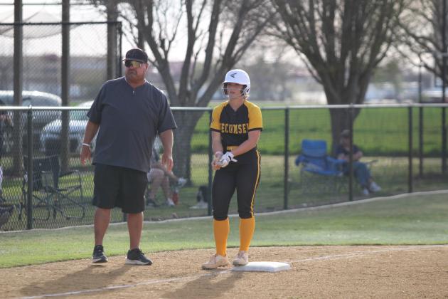 Head Slow Pitch Coach Perry Wilson talks with Katie Overstreet at third base.