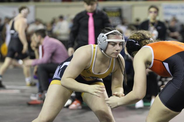 Tecumseh senior Trinity Rakestraw sizes up her opponent for a take-down during the OSSAA Class 5A Girls Wrestling State Championship on March 1 at the State Fair Arena. Rakestraw lost the match but took runner-up in her weight division. She also reached 100 wins on Feb. 28. Countywide &amp; Sun/Natasha Dunagan
