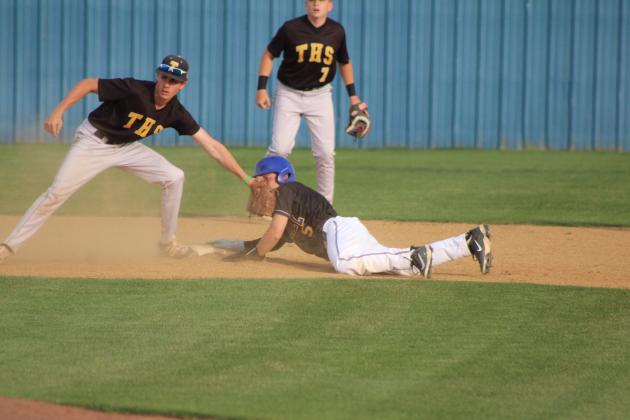 Bethel junior Gavin Lynch dives into second base as Tecumseh junior Elias Hasler tags him during the double header at Bethel on April 17. The Savages won both games, 3-12 and 1-12. Natasha Dunagan, Countywide &amp; Sun