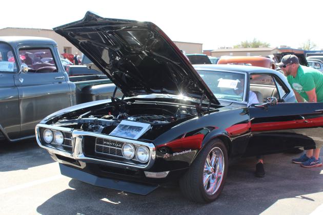 During the Bethel Band Boosters Car Show on April 12, Michael Jenkins, right, of Bethel, talks with J.D. Watkins of Sulphur, as he revs up the 5.7 Corvette engine in his 1968 Pontiac Firebird. Natasha Dunagan, Countywide &amp; Sun
